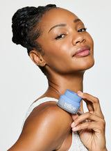 Trillion unreal dewy moisturizer woman holding can