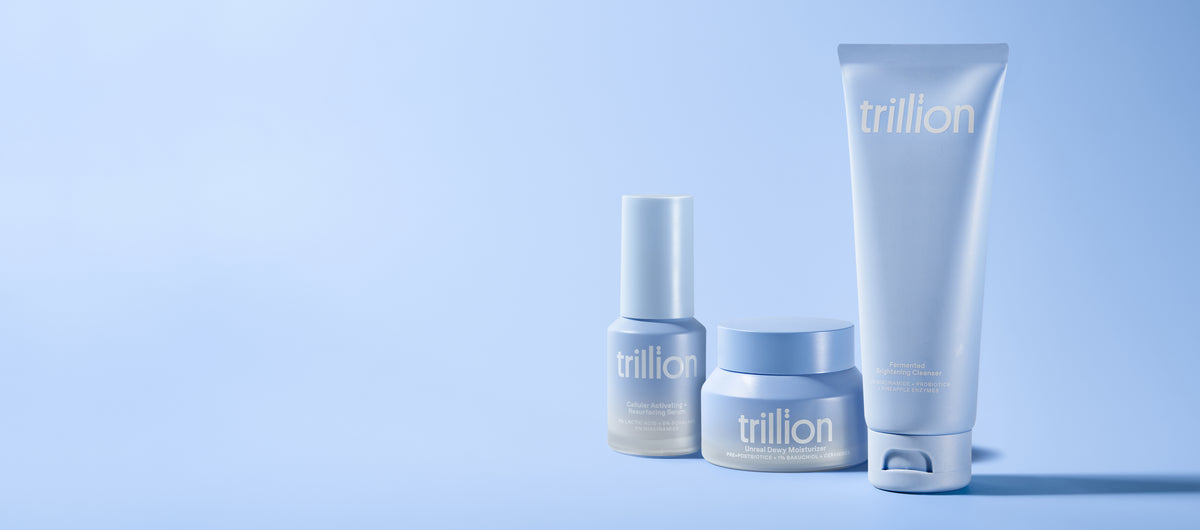 The trillion cleanser, serum and moisturizer photographed together on blue